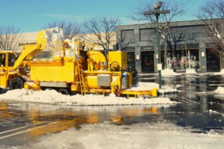 Snow Melter in the Parking Lot of a Shopping Plaza