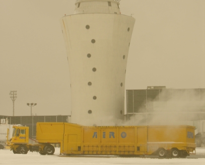 Snow Melter in Front of an Air Traffic Control Tower